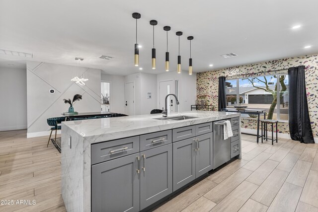 kitchen featuring dishwasher, visible vents, a sink, and gray cabinets