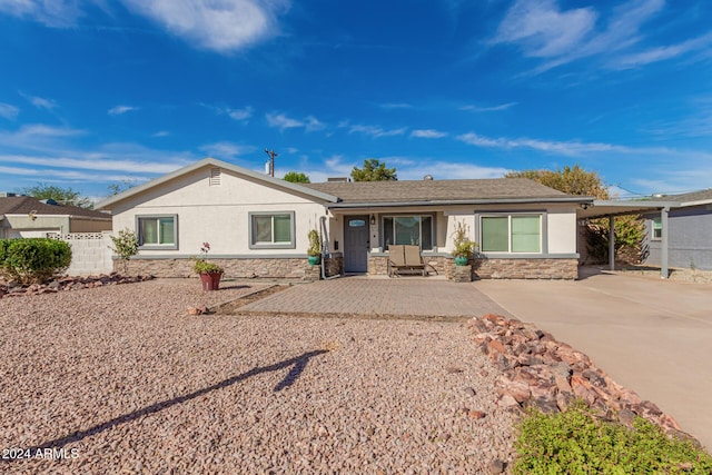 2518 E Campbell Ave, Phoenix, AZ 85016 - single story home featuring stone siding, stucco siding, a carport, fence, and driveway