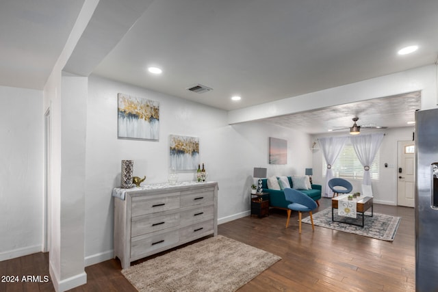 living area with ceiling fan and dark hardwood / wood-style floors