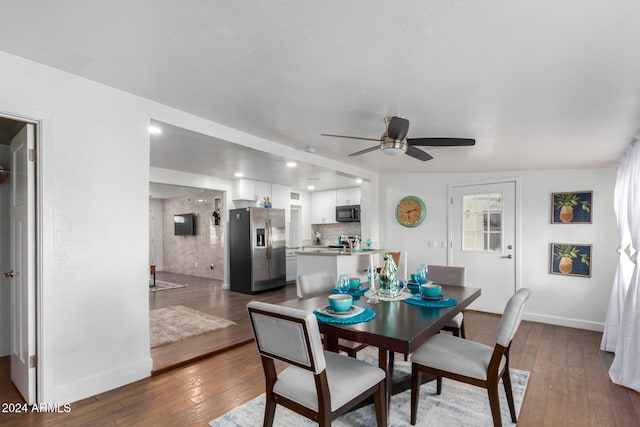 dining space with dark hardwood / wood-style flooring and ceiling fan