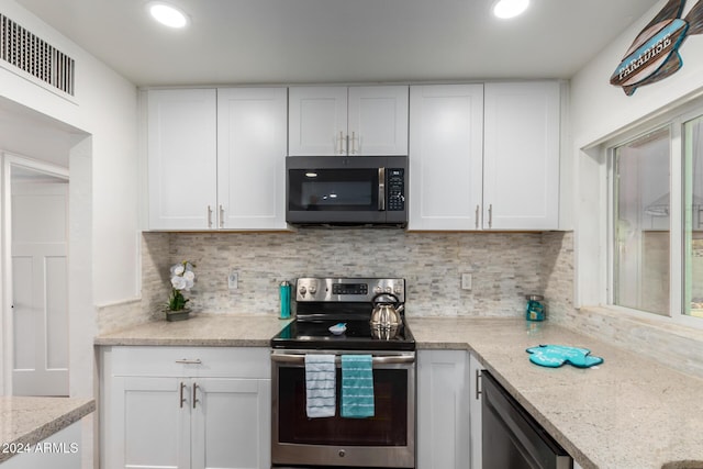 2518 E Campbell Ave, Phoenix, AZ 85016 - kitchen featuring stainless steel appliances, white cabinets, backsplash, recessed lighting, and light stone counters