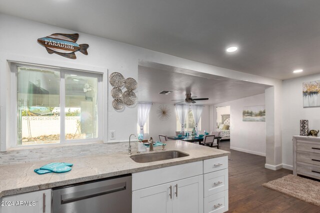 kitchen with white cabinetry, sink, dark wood-type flooring, stainless steel dishwasher, and ceiling fan