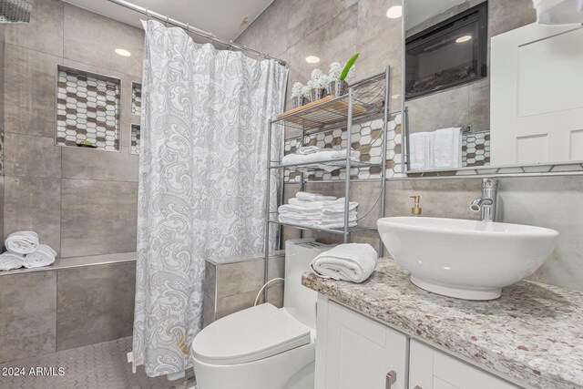 2518 E Campbell Ave, Phoenix, AZ 85016 - full bath featuring tile walls, a tile shower, vanity, and toilet
