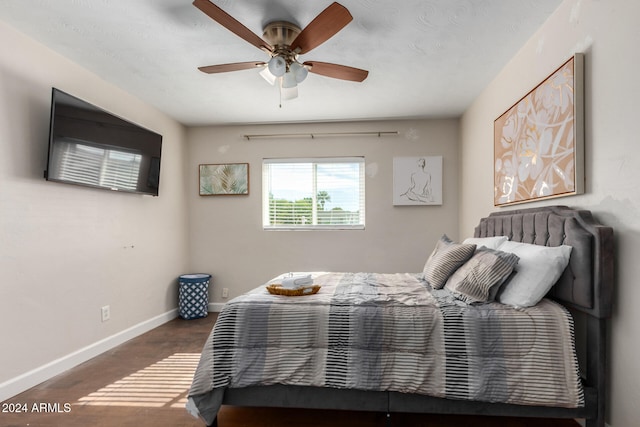 bedroom with ceiling fan and wood-type flooring