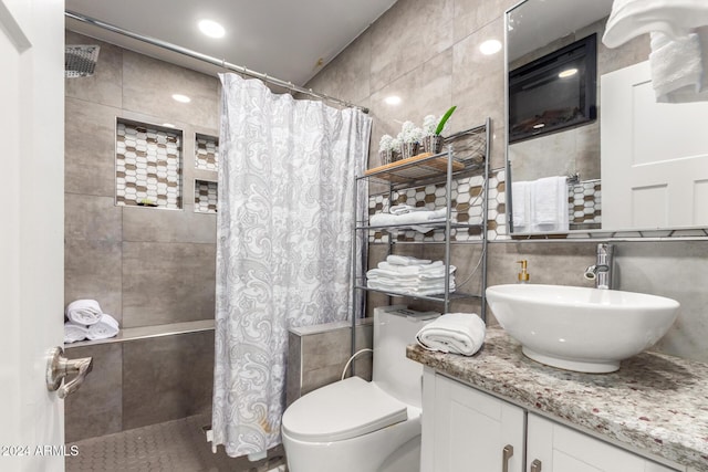 2518 E Campbell Ave, Phoenix, AZ 85016 - full bathroom with tile walls, tiled shower, vanity, toilet, and backsplash