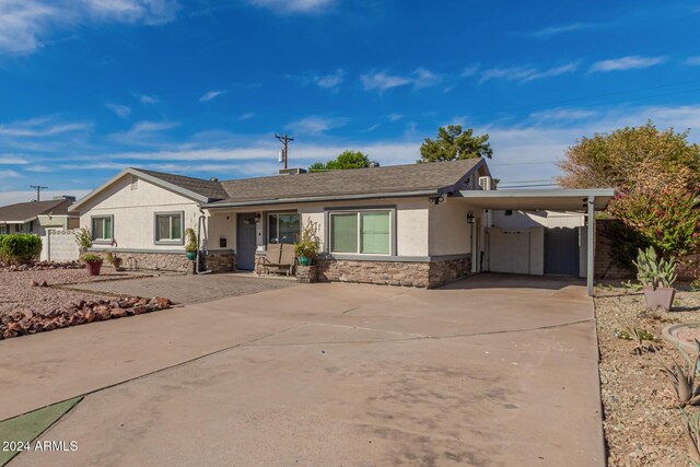 2518 E Campbell Ave, Phoenix, AZ 85016 - ranch-style home with stucco siding, stone siding, concrete driveway, and a carport