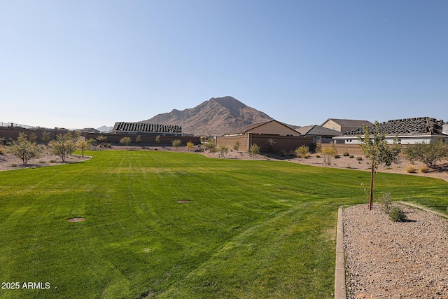 view of yard with fence and a mountain view