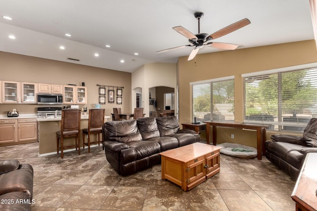 4038 E Wrangler Ct, Gilbert, AZ 85297 - living room with arched walkways, recessed lighting, a ceiling fan, and high vaulted ceiling