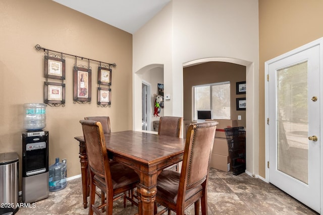 4038 E Wrangler Ct, Gilbert, AZ 85297 - dining room with arched walkways, french doors, and baseboards