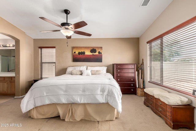 4038 E Wrangler Ct, Gilbert, AZ 85297 - bedroom featuring light colored carpet, arched walkways, ensuite bath, and a ceiling fan