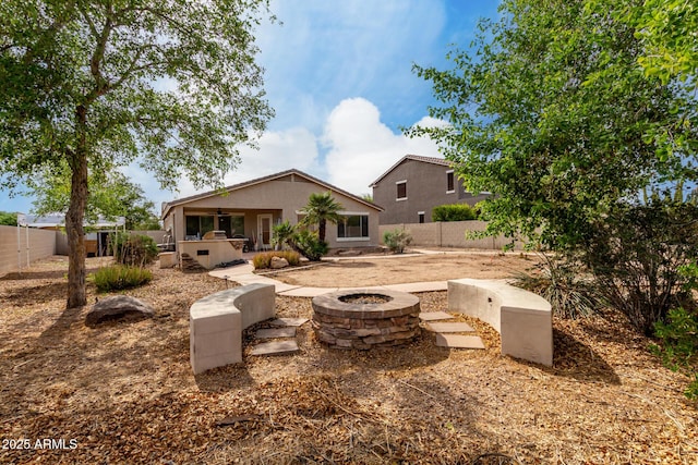 4038 E Wrangler Ct, Gilbert, AZ 85297 - rear view of house featuring a fire pit, a fenced backyard, stucco siding, and a patio