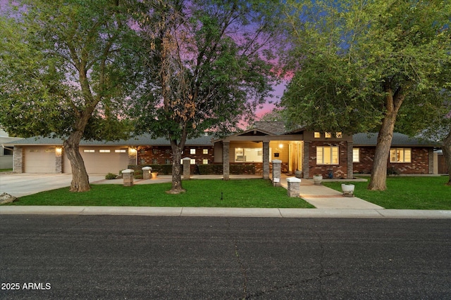 5535 N 13th St, Phoenix, AZ 85014 - mid-century modern home featuring brick siding, a garage, driveway, and a front lawn