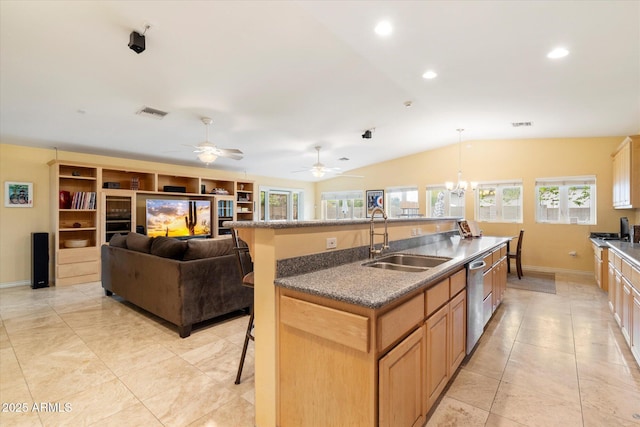 5535 N 13th St, Phoenix, AZ 85014 - kitchen with a center island with sink, a sink, vaulted ceiling, a kitchen bar, and stainless steel dishwasher