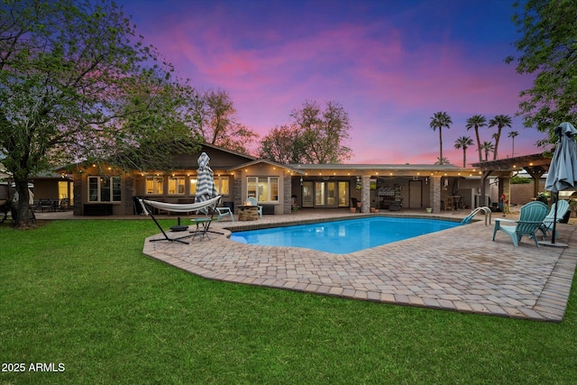5535 N 13th St, Phoenix, AZ 85014 - pool at dusk featuring a patio area, an outdoor pool, and a yard