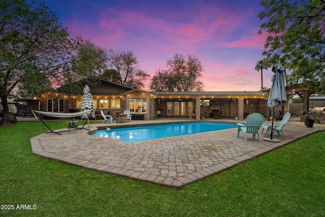 5535 N 13th St, Phoenix, AZ 85014 - pool at dusk featuring a patio area, an outdoor pool, and a yard