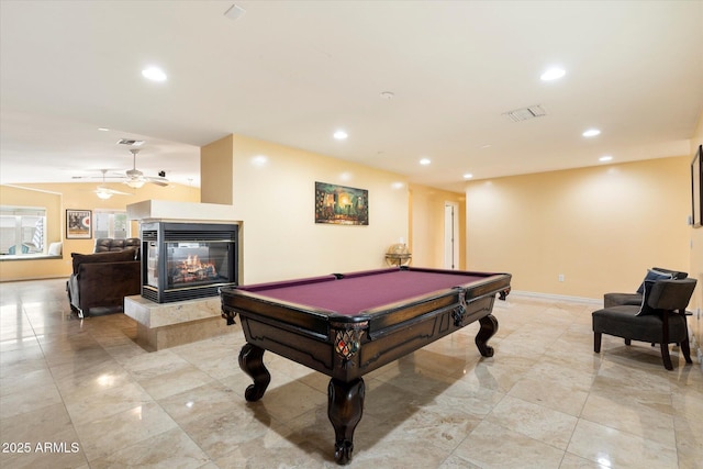 5535 N 13th St, Phoenix, AZ 85014 - recreation room with visible vents, baseboards, a multi sided fireplace, recessed lighting, and a ceiling fan