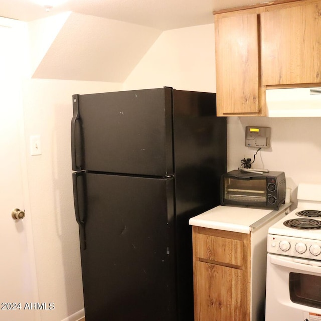 kitchen with black fridge, exhaust hood, and white electric stove