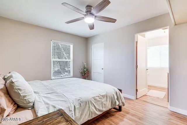 2723 Towell St, Overgaard, AZ 85933 - bedroom with baseboards, light wood-style flooring, a ceiling fan, and connected bathroom
