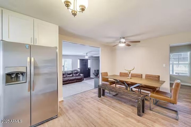 2723 Towell St, Overgaard, AZ 85933 - dining room with light wood-style flooring, a ceiling fan, baseboards, and a chandelier