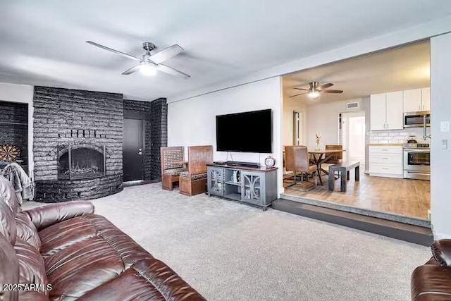 2723 Towell St, Overgaard, AZ 85933 - living area featuring a ceiling fan, a fireplace, and carpet flooring