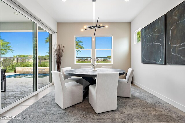 dining area with a notable chandelier and hardwood / wood-style floors