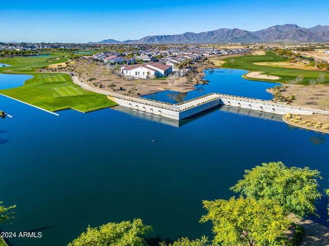 birds eye view of property with a water and mountain view