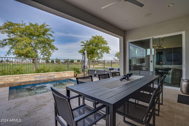 view of patio with a fenced in pool and ceiling fan