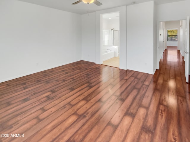 unfurnished bedroom with dark hardwood / wood-style flooring and ensuite bath