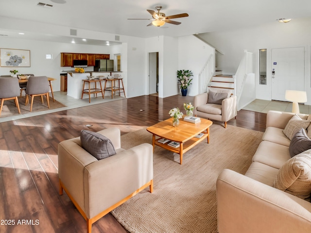 living room with ceiling fan and light hardwood / wood-style flooring