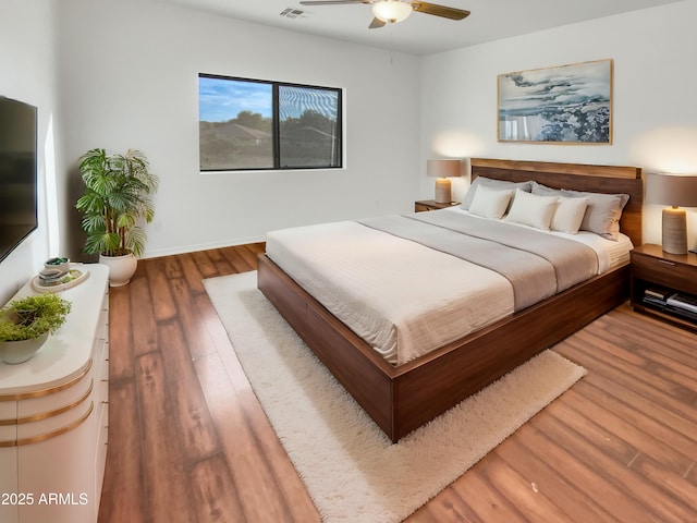 bedroom with ceiling fan and hardwood / wood-style floors