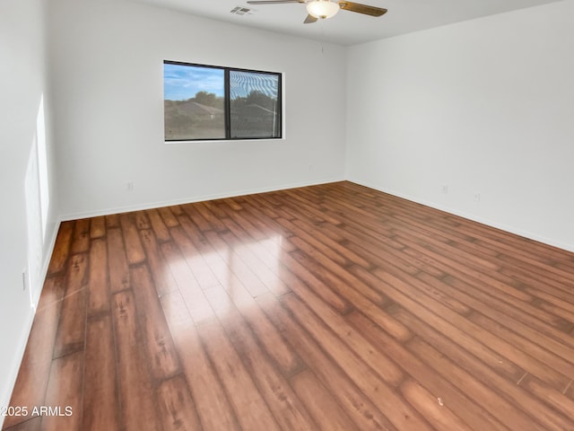 empty room with hardwood / wood-style floors and ceiling fan