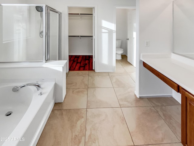 bathroom with tile patterned flooring, plus walk in shower, and toilet