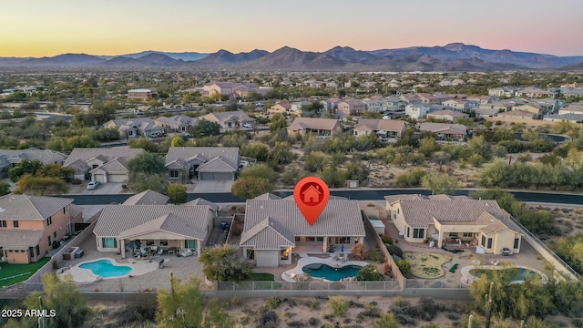 aerial view at dusk featuring a mountain view