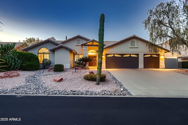 12754 E Laurel Ln, Scottsdale, AZ 85259 - view of front facade with a garage, stucco siding, concrete driveway, and a tiled roof