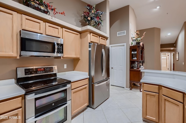 12754 E Laurel Ln, Scottsdale, AZ 85259 - kitchen with stainless steel appliances, light brown cabinets, light countertops, light tile patterned floors, and recessed lighting