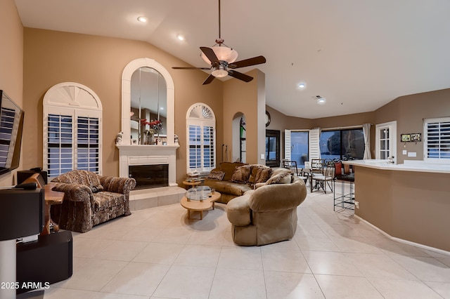 12754 E Laurel Ln, Scottsdale, AZ 85259 - living room with vaulted ceiling, ceiling fan, light tile patterned flooring, a fireplace, and recessed lighting