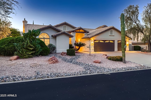 12754 E Laurel Ln, Scottsdale, AZ 85259 - view of front of property with a garage, concrete driveway, a chimney, stucco siding, and a tiled roof