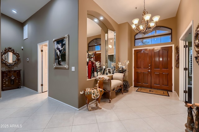12754 E Laurel Ln, Scottsdale, AZ 85259 - foyer entrance with high vaulted ceiling, a chandelier, light tile patterned floors, arched walkways, and baseboards