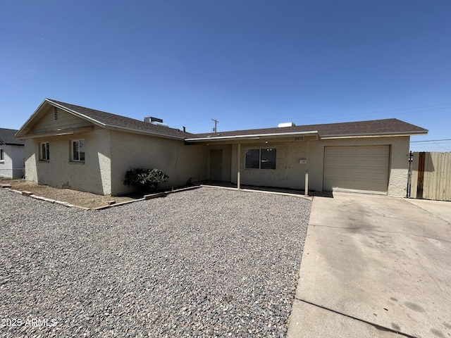3814 N 55th Dr, Phoenix, AZ 85031 - ranch-style house featuring an attached garage, driveway, and stucco siding
