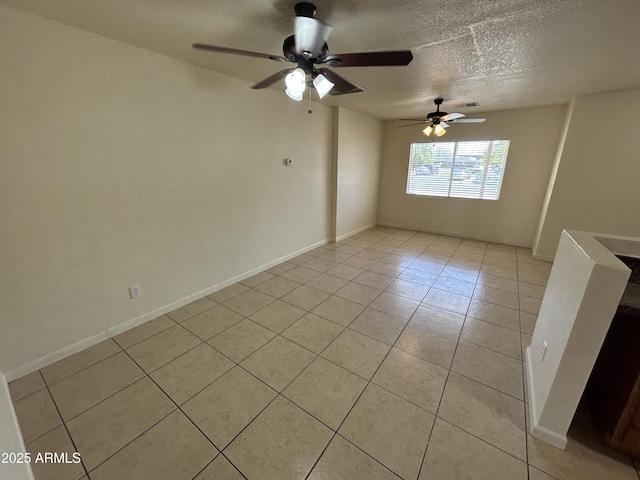 3814 N 55th Dr, Phoenix, AZ 85031 - empty room with light tile patterned floors, ceiling fan, and a textured ceiling
