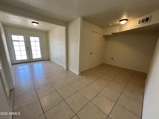 3814 N 55th Dr, Phoenix, AZ 85031 - empty room featuring light tile patterned floors, french doors, and baseboards