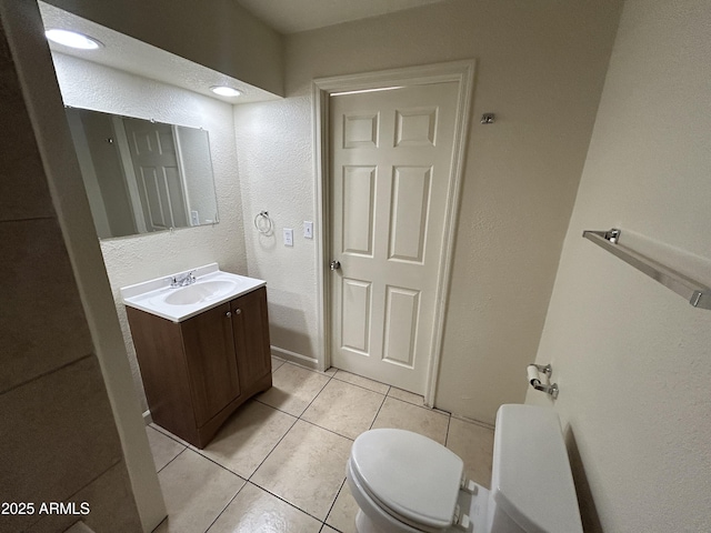 3814 N 55th Dr, Phoenix, AZ 85031 - bathroom featuring toilet, vanity, tile patterned floors, and a textured wall