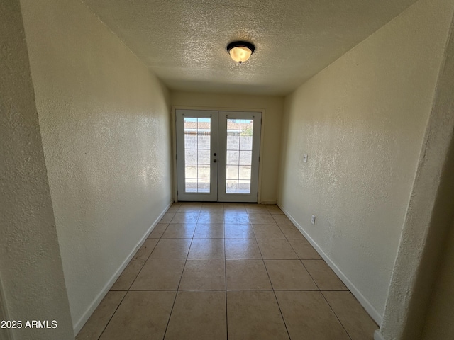 3814 N 55th Dr, Phoenix, AZ 85031 - doorway to outside featuring french doors, a textured wall, baseboards, light tile patterned floors, and a textured ceiling
