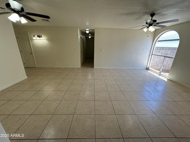 3814 N 55th Dr, Phoenix, AZ 85031 - unfurnished room with a ceiling fan, light tile patterned flooring, a textured ceiling, and baseboards