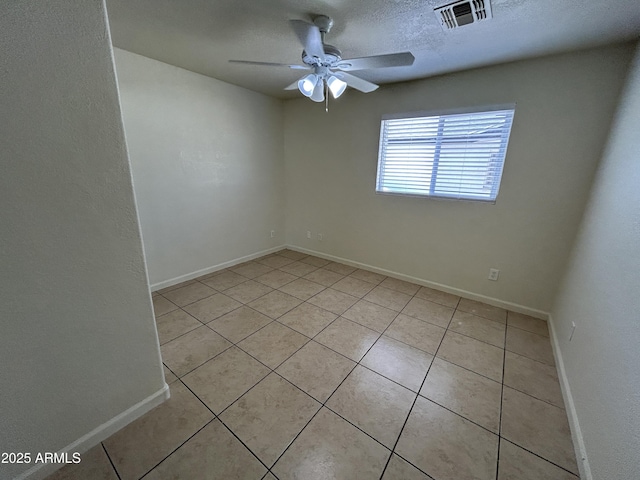 3814 N 55th Dr, Phoenix, AZ 85031 - empty room featuring ceiling fan, light tile patterned flooring, baseboards, and a textured ceiling