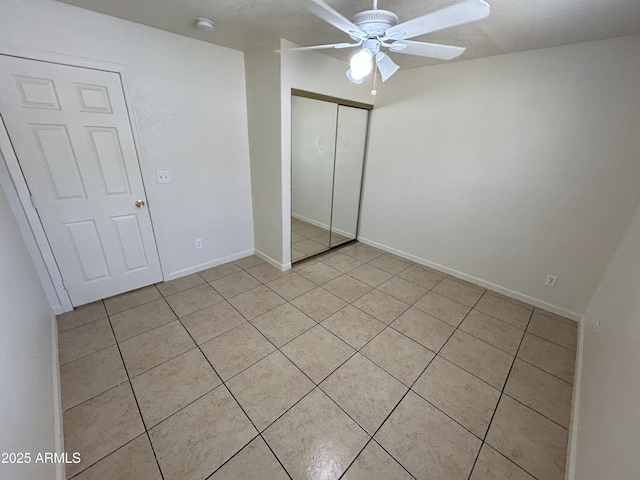 3814 N 55th Dr, Phoenix, AZ 85031 - unfurnished bedroom featuring light tile patterned floors, a closet, baseboards, and a ceiling fan