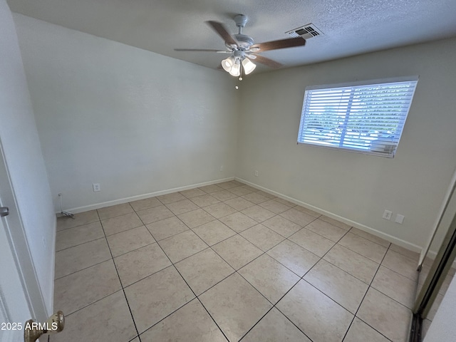 3814 N 55th Dr, Phoenix, AZ 85031 - empty room with a ceiling fan, light tile patterned floors, a textured ceiling, and baseboards