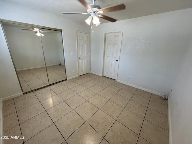 3814 N 55th Dr, Phoenix, AZ 85031 - unfurnished bedroom featuring light tile patterned floors, a closet, ceiling fan, and baseboards