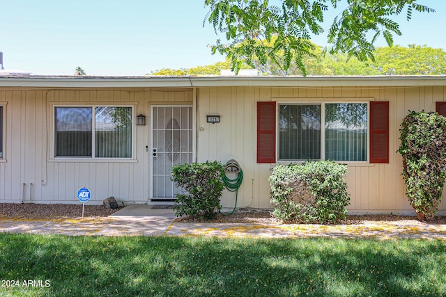 doorway to property featuring a yard