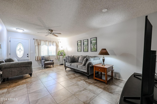 tiled living room featuring a textured ceiling and ceiling fan